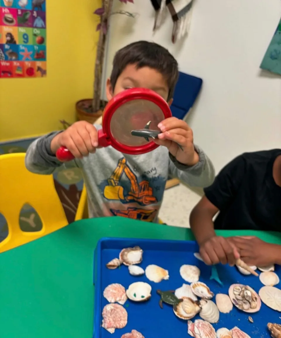 Child with magnifying glass at Inspire