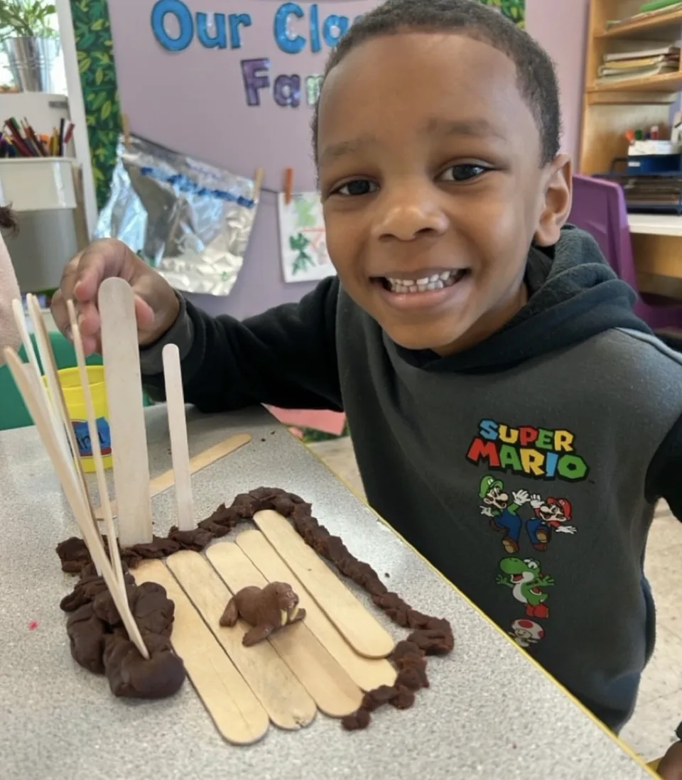Smiling child sharing a classroom project